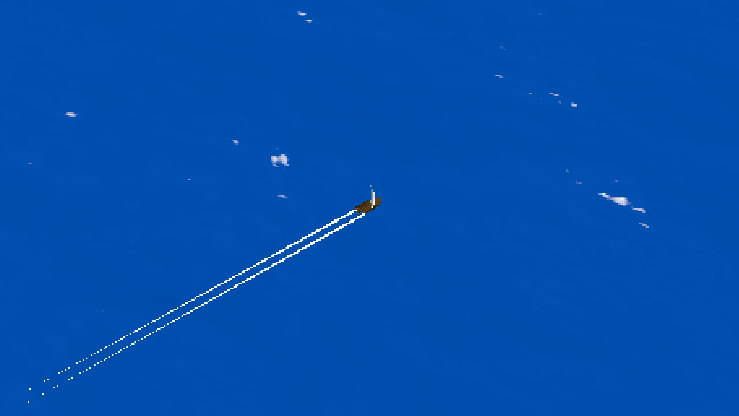A small sailboat cutting across open blue water, leaving a white wake behind it